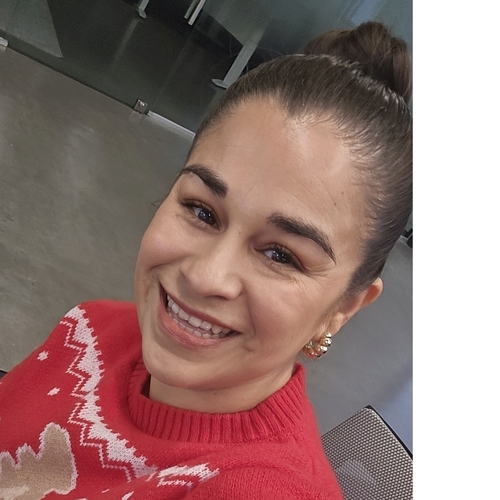 SFSU graduate student, smiling, wearing red sweater